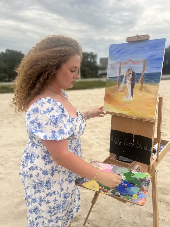 Katie painting live on the beach