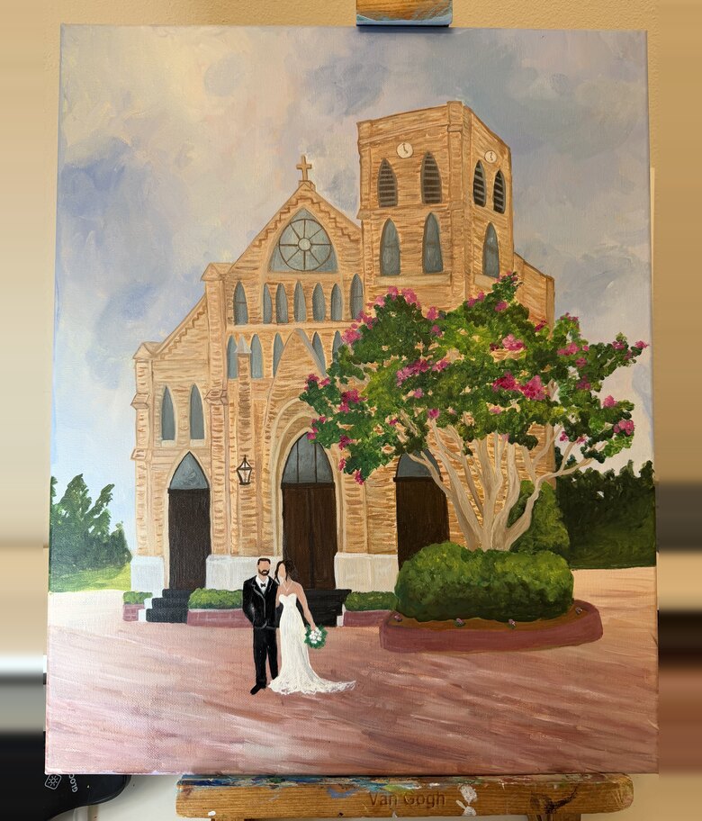 Live wedding painting of a bride and groom before a stone church beneath a blooming crepe myrtle, on the easel in the studio