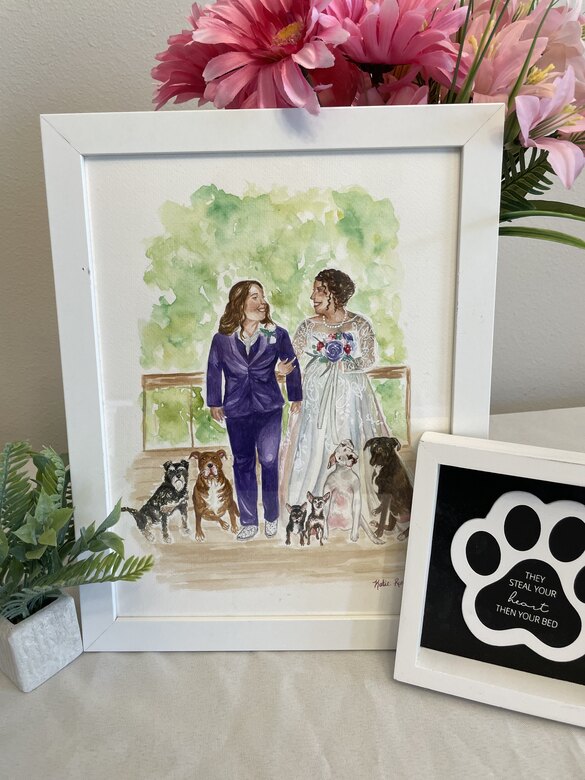 Framed watercolor portrait of a couple with their dogs