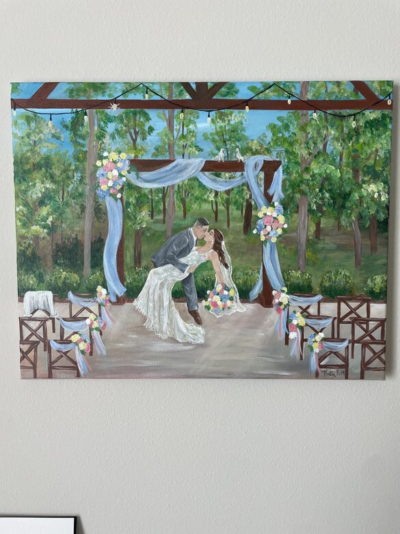 Live painting of a wedding ceremony beneath an arbor