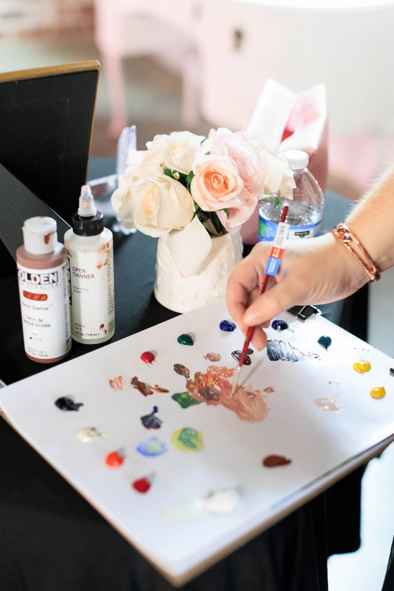 Katie's paint palette, brushes and flowers at a live event