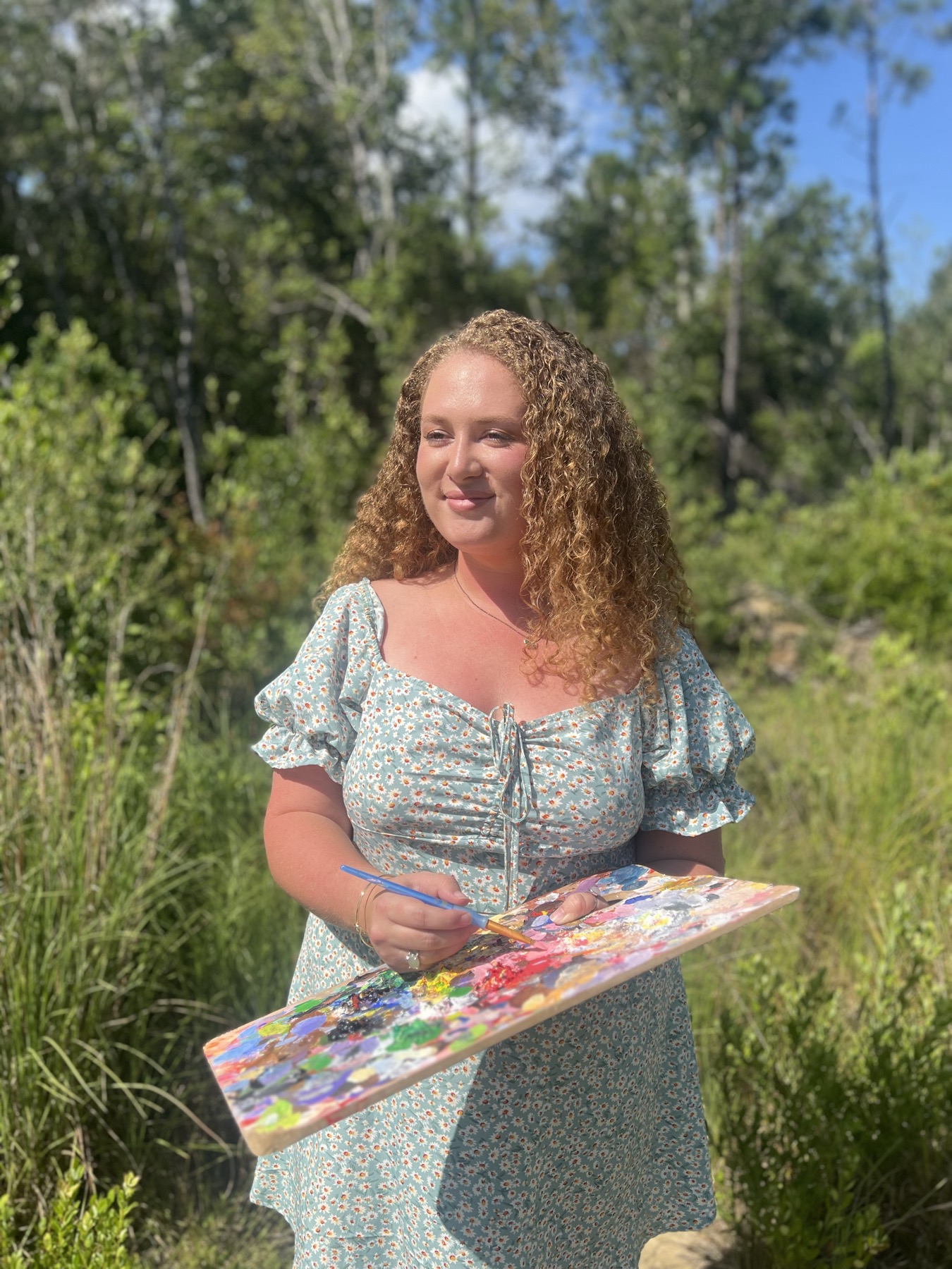 Katie holding one of her live event paintings