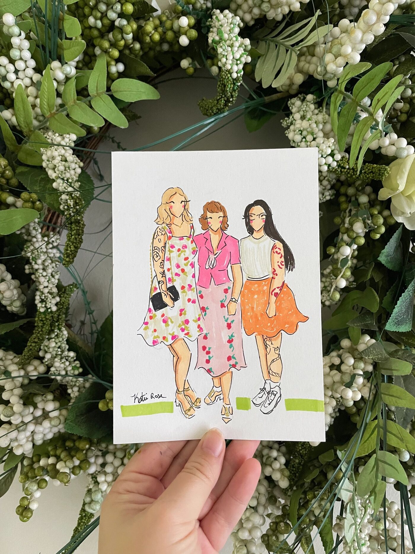 Fashion illustration of three guests, held against the greenery