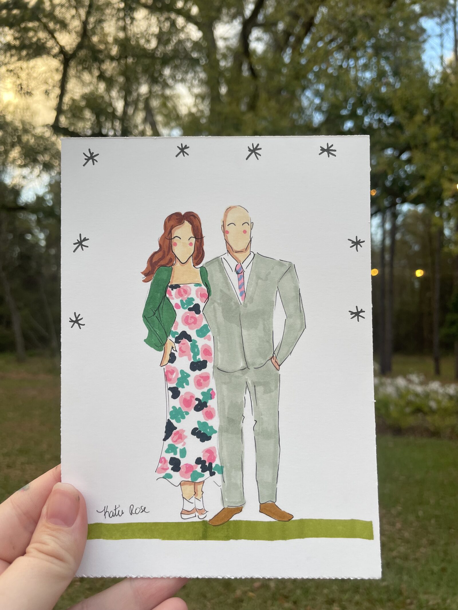 Fashion illustration of a couple, held up at the venue